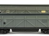 three toy trains that are sitting on a white surface