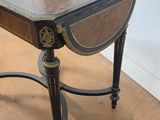 a small table with a black and gold decoration on it