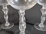 four wine glasses sitting next to each other on a table
