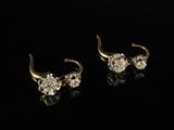 a pair of gold and diamond earrings