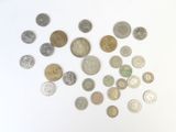 a lot of coins that are on a white surface