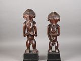 a pair of carved wooden figures of a man and woman