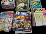 a lot of comic books that are sitting on a table