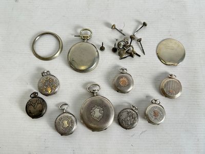 many different types of pocket watches on the table
