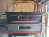 three ovens stacked on top of each other in a kitchen
