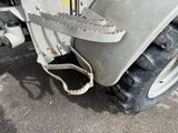 a close up of a tractor with a chain attached to it ' s tire