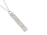 an art deco silver pendant with a filigree design on a chain