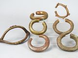 several different types of metal rings on display on a white surface