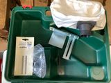a green box with a knife and other items in it