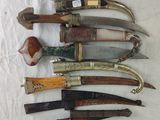 several different types of knives are lined up on a table