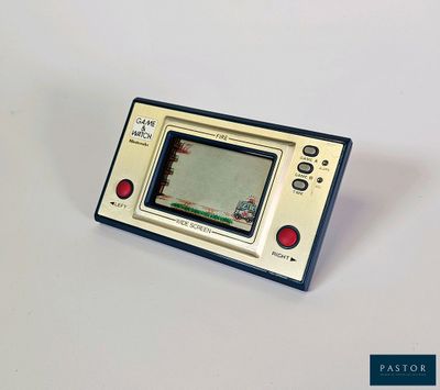 a small gameboy sitting on top of a white table