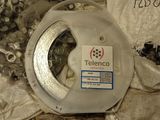 a reel of silver wire on top of a piece of cloth