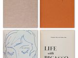 three books with drawings of a woman ' s face and a man ' s face on them