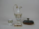 a white and gold vase and a small cup and a small box