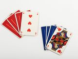 playing cards with red and blue playing cards on a white surface