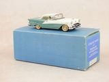 une petite voiture posée sur une boîte bleue
