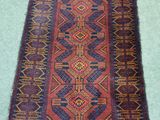 a close up of a rug on a green surface