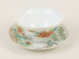 a cup and saucer on a saucer on a white table