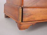 a close up of a wooden dresser on a table