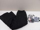 a pair of black pants and a stuffed animal on a white table