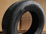 tires are stacked on the floor in front of a cardboard box