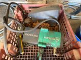 a basket with a chain and a tool in it
