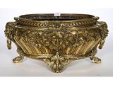 an antique brass planter with ornate carvings on the sides