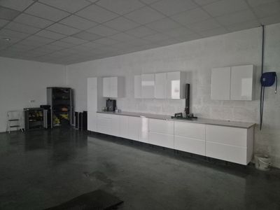 an image of a kitchen with white cabinets and appliances
