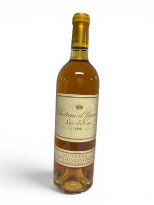 a close up of a bottle of wine on a white surface