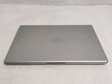 a laptop that is sitting on a bed with a white sheet