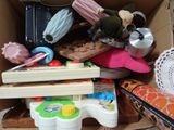 a cardboard box filled with toys and other items