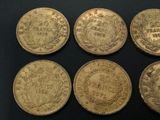 six different types of gold coins on a black surface