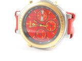 a close up of a red and gold watch on a white surface