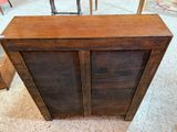 a wooden cabinet that has two doors on it
