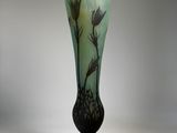 a glass vase with a flower design on it