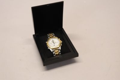 a watch in a black box on a white table