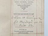 an old book with writing on it sitting on top of a table