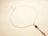 a necklace that has a long cord attached to it