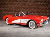 a red and white car parked in front of a brick wall