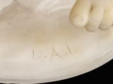 a statue of a cat that is sitting on a plate