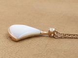 gold plated necklace with a white tear shaped pendant on a gold chain