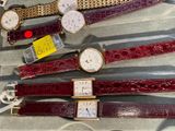 a lot of watches that are sitting on a table