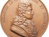 an image of a bronze medal with a portrait of a man