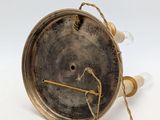 an old fashioned brass clock with a rope around it ' s neck