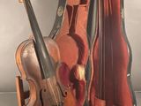 a violin and a violin case sitting on a table