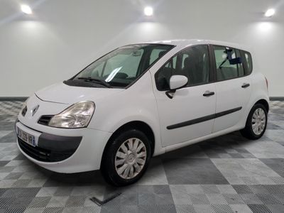 a picture of a small white car parked in a garage