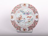 a plate with a design on it sitting on a stand