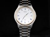 a silver watch with roman numerals on the face