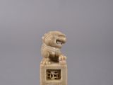 a small statue of a lion on top of a box