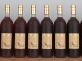 six bottles of wine lined up in a row on a table